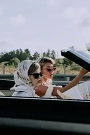 Vintage photograph of two female tourists in a car